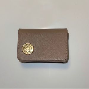 Vince Camuto brown card wallet with gold logo.